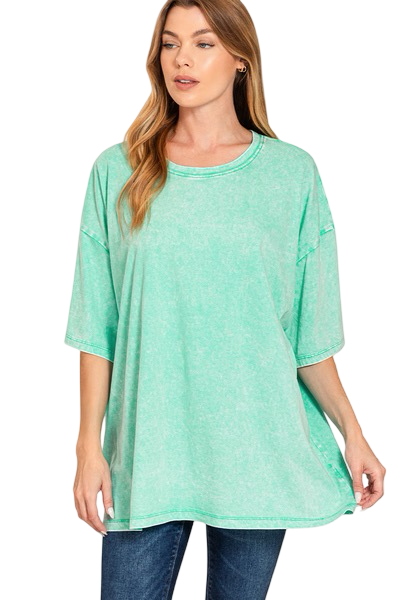Woman wearing a green tunic with a white background