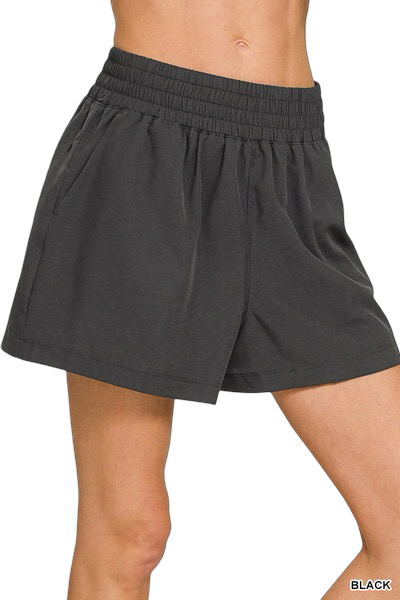 Black shorts worn by a person on a white background