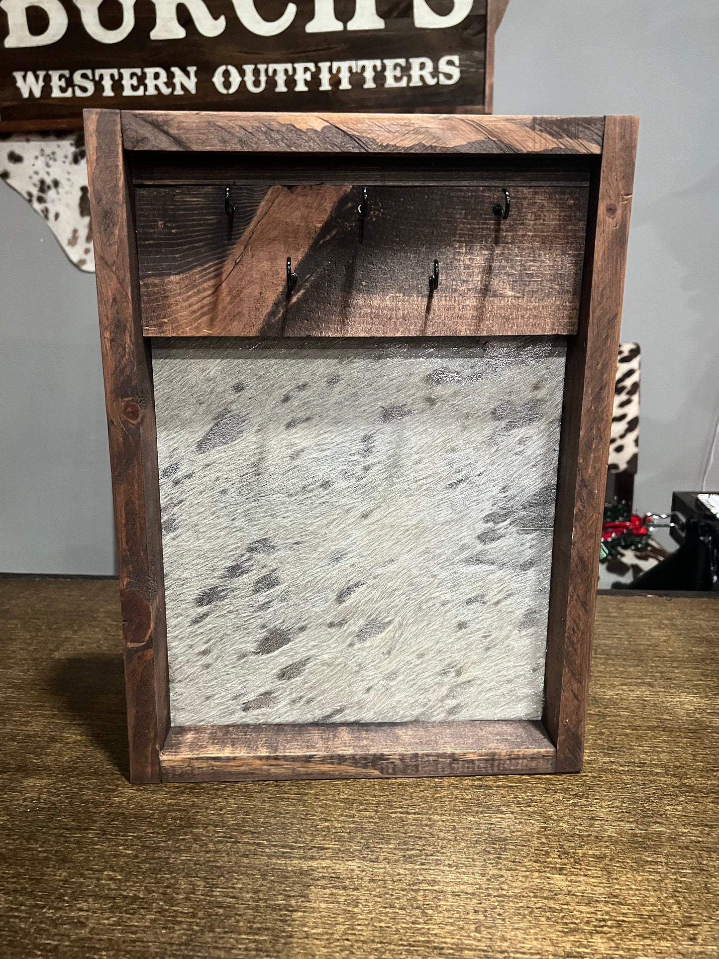 Wooden frame with metal panel on a textured wall