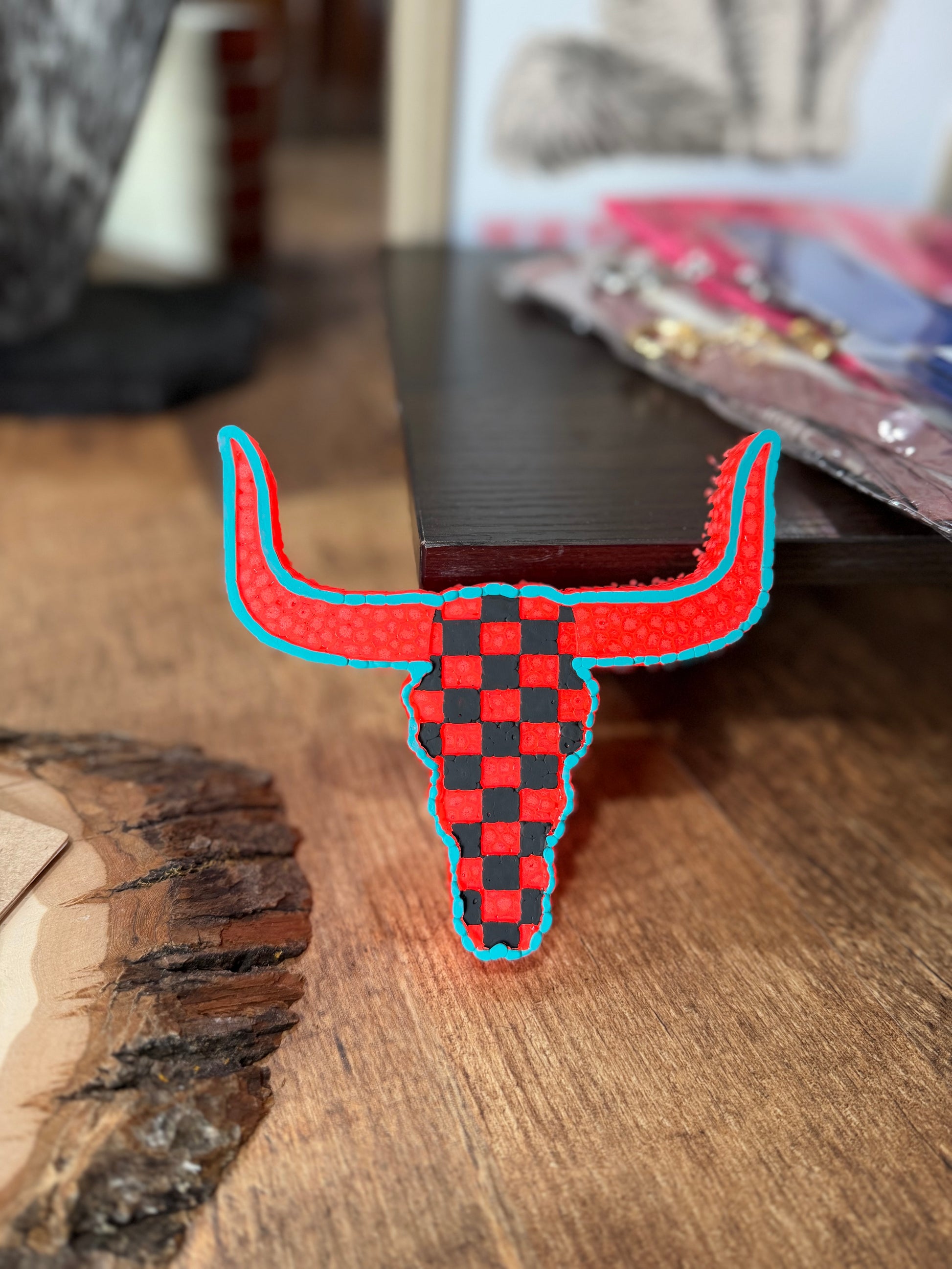 Checkered bull head Freshie on a wooden surface
