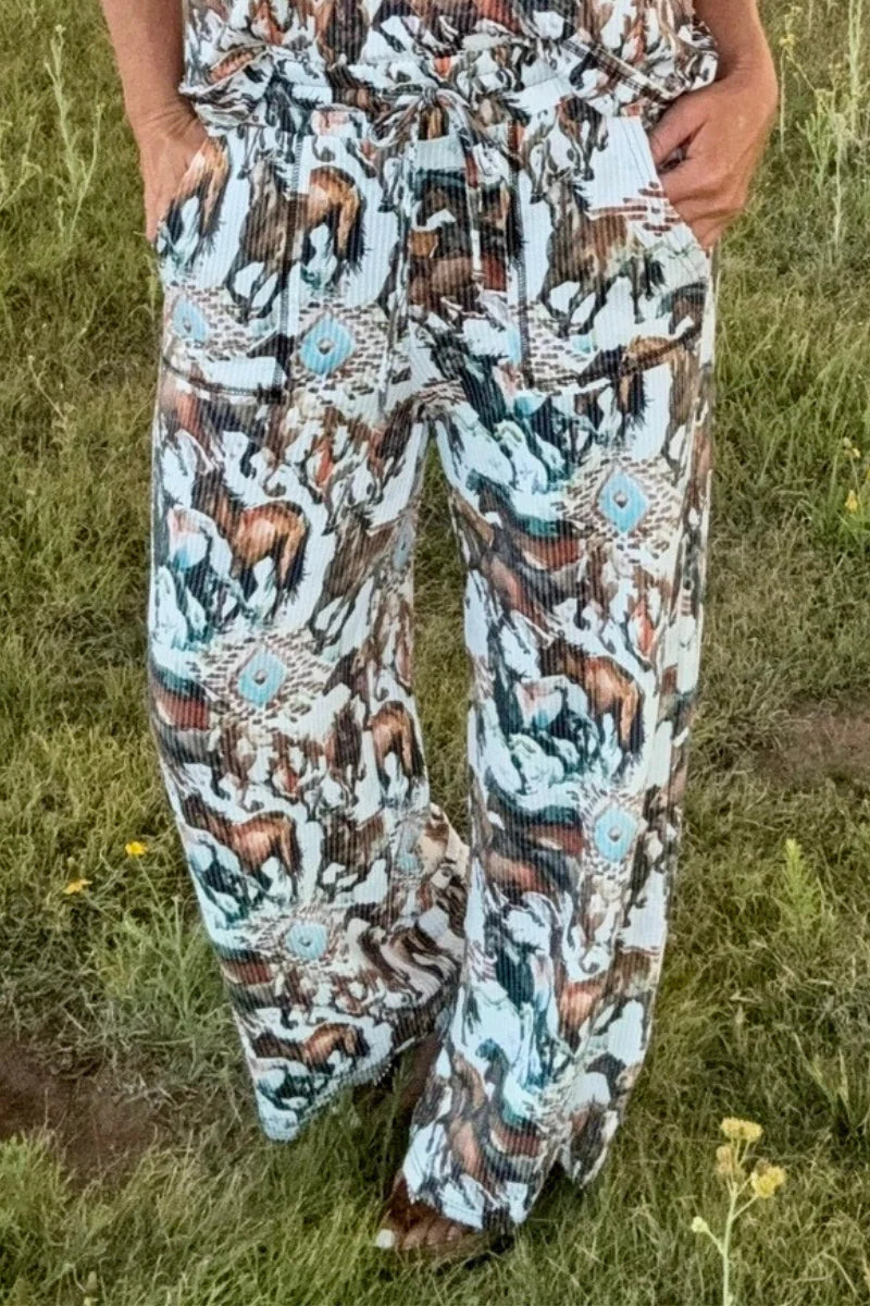 Person wearing a patterned outfit with a horse design in a grassy outdoor setting
