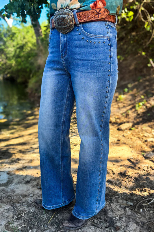 Jeans with studs down seems on outside of leggings and pockets infront and back