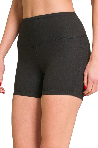 Black athletic shorts worn by a person on a white background