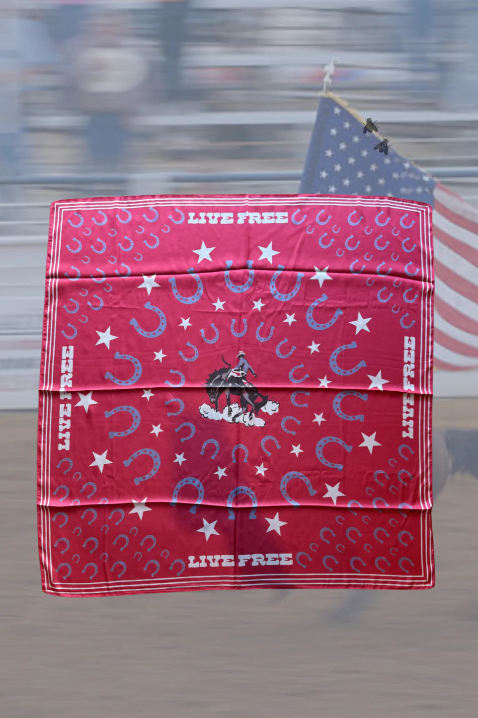 Red bandana with horse and star pattern and 'Live Free' text, displayed in front of an American flag.