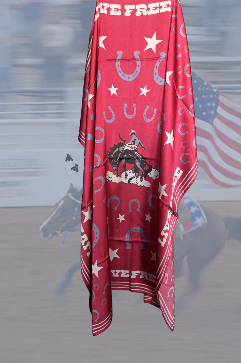Red scarf with horse and star pattern on a blurred background