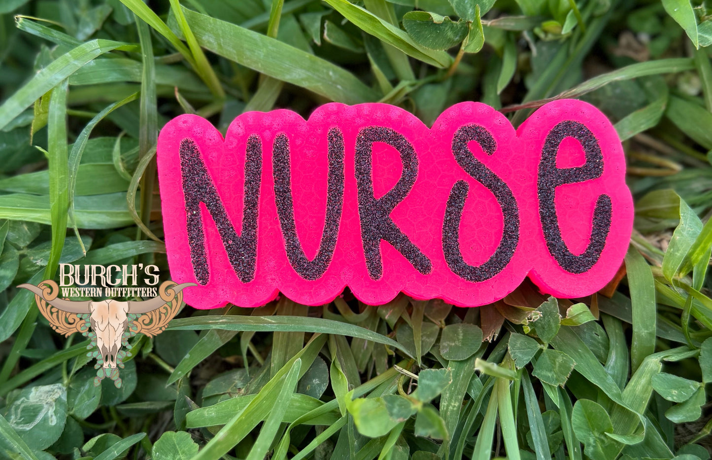Pink freshie with 'NURSE' on grass