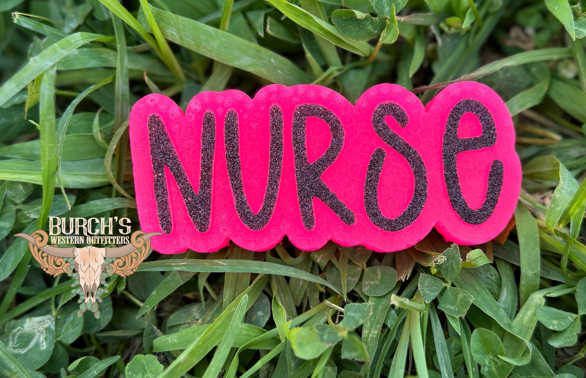 Pink freshie with 'NURSE' on grass
