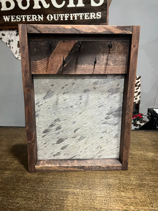 Wooden frame with metal panel on a textured wall