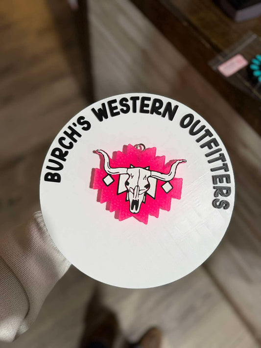 Round sticker with 'Burch's Western Outfitters' logo featuring a bull skull on a pink background.