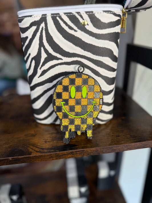 Zebra-patterned pouch with a checkered glitter smiley face Freshie 