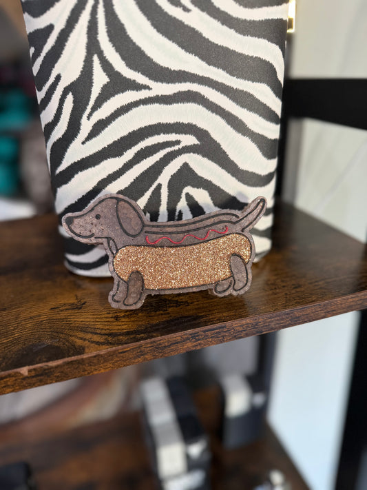  hot dog with a dog inside design on a wooden surface