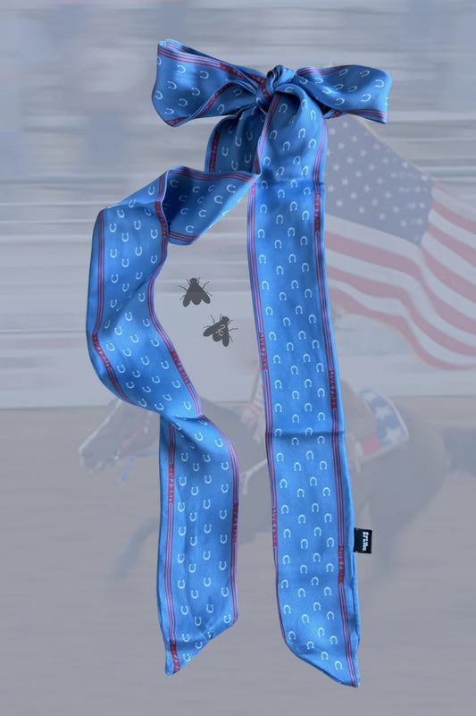 Blue patterned scarf with a bow on a blurred background