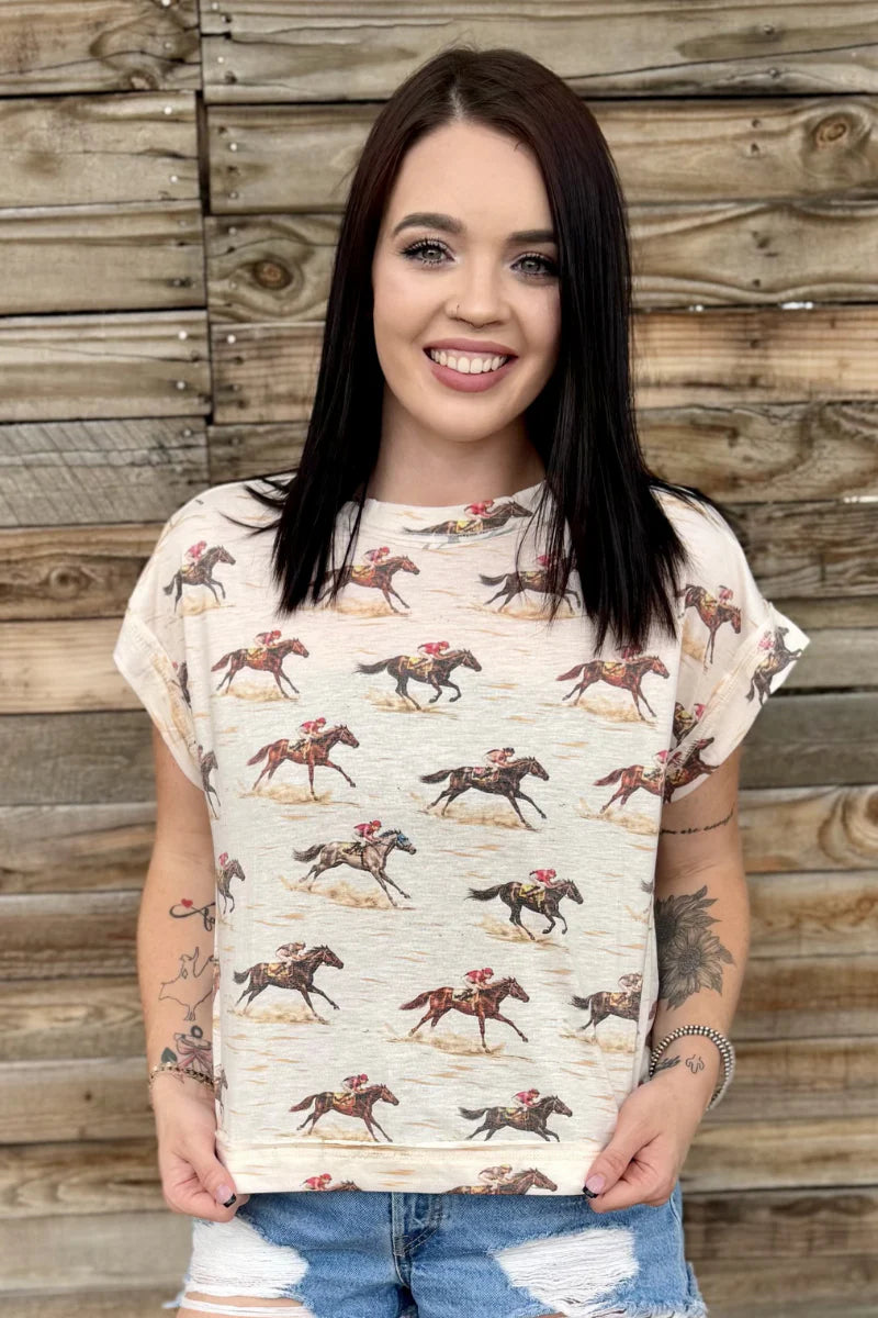 Woman wearing a t-shirt with horse prints against a wooden background